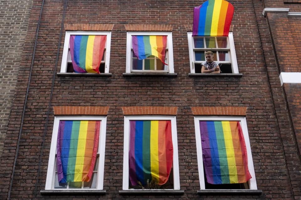 Rainbow flags cover a set of windows in Soho as members of the LGBT community hold the annual Pride Parade in London in July 2019 (AFP via Getty Images)