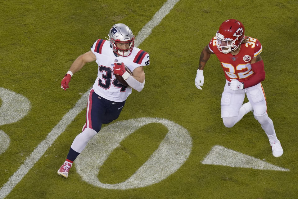 New England Patriots running back Rex Burkhead (34) runs from Kansas City Chiefs safety Tyrann Mathieu (32) during the first half of an NFL football game, Monday, Oct. 5, 2020, in Kansas City. (AP Photo/Charlie Riedel)