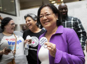 Sen. Mazie Hirono, D-Hawaii, a member of the Senate Judiciary Committee, is welcomed by protesters opposed to President Donald Trump's Supreme Court nominee, Brett Kavanaugh, as they demonstrate in the Hart Senate Office Building on Capitol Hill in Washington, Thursday, Sept. 20, 2018. Kavanaugh has denied stories of a sexual assault as alleged by California college professor Christine Blasey Ford. (AP Photo/J. Scott Applewhite)