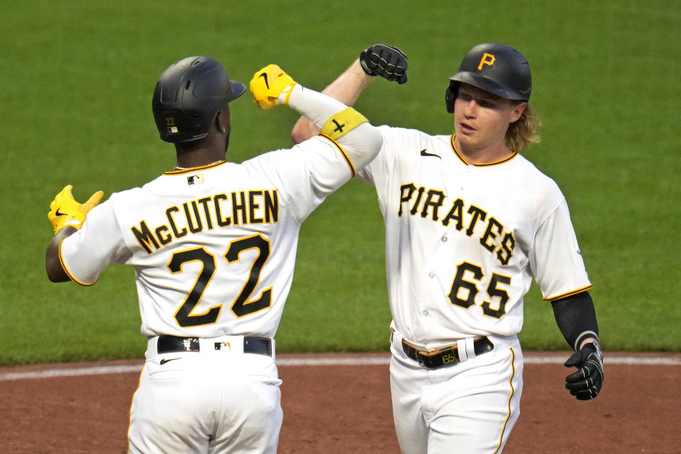 Pittsburgh Pirates' Jack Suwinski (65) celebrates with Andrew McCutchen (22) as he crosses home plate after hitting a two-run home run off Milwaukee Brewers starting pitcher Corbin Burnes during the fourth inning of a baseball game in Pittsburgh, Monday, Sept. 4, 2023. (AP Photo/Gene J. Puskar)