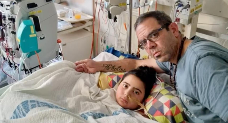 Nicholas Tadros and his dad Simon in hospital. 