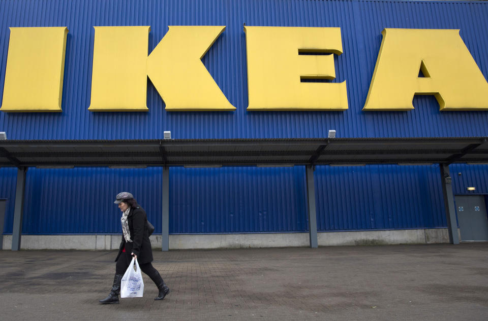 A shopper walks past a sign outside an IKEA store in Wembley, north London January 28, 2015.  IKEA Group, the world's biggest furniture retailer, posted on Wednesday a fiscal full-year net profit that was unchanged from the year before and said the European market continued to improve. REUTERS/Neil Hall (BRITAIN - Tags: BUSINESS SOCIETY)