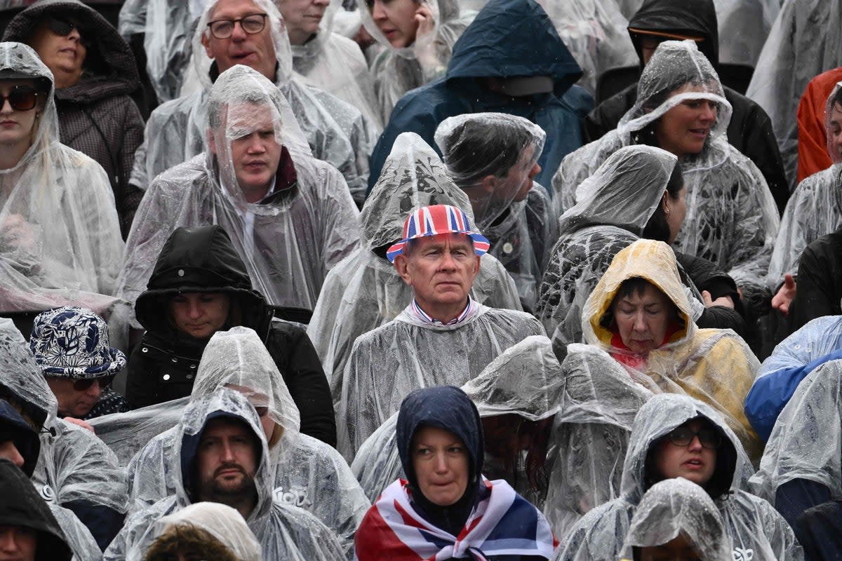 Downpours on Saturday did little to dampen enthusiasm (AFP via Getty)