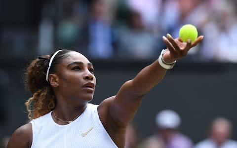 Williams serves on Centre Court - Credit: AFP