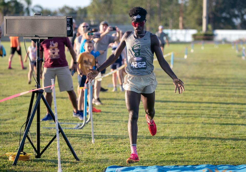 George Jenkins' Caden Lewis runs across the finish line in first place on Saturday at the Polk County Cross Country Meet at Lake Region High School.