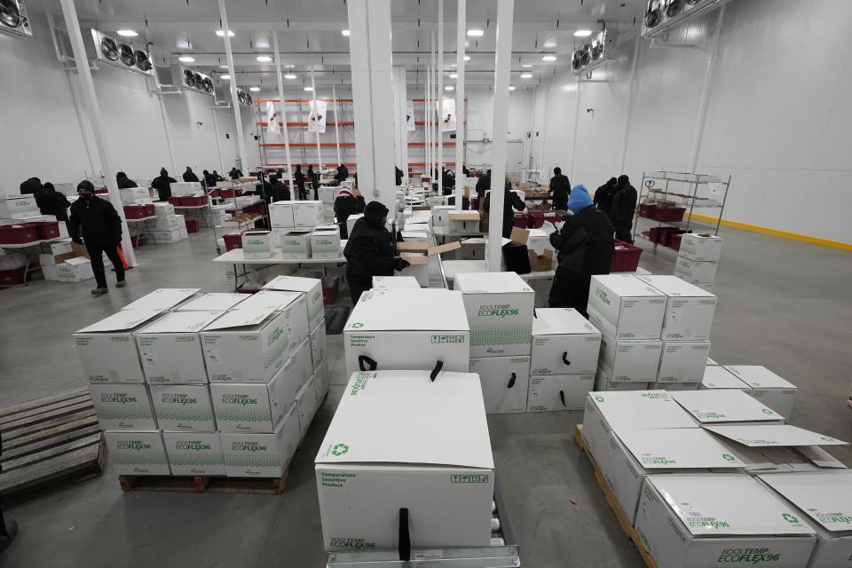 Boxes containing the Moderna COVID-19 vaccine are prepared to be shipped at the McKesson distribution center in Olive Branch, Miss. 