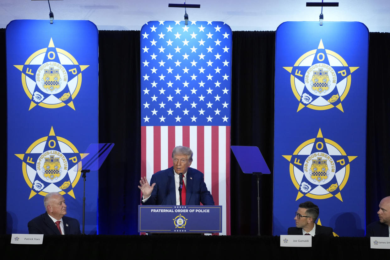 Republican presidential nominee former President Donald Trump speaks to the National Fraternal Order of Police fall meeting, Friday, Sept. 6, 2024, in Charlotte, N.C., as FOP president Patrick Yoes, left, and FOP vice president Joe Gamaldi listen. (AP Photo/Evan Vucci)