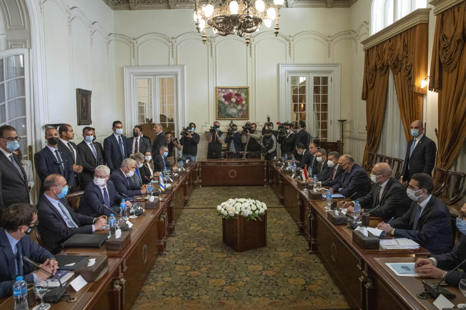 Israeli Foreign Minister Yair Lapid, center left, meets with Egyptian Foreign Minister Sameh Shoukry at Tahrir Palace in Cairo, Egypt, Thursday, Dec. 9, 2021. (AP Photo/Nariman El-Mofty)