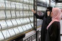 A woman looks at jewellery at a shop in the gold market in Riyadh