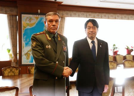 General Valery Gerasimov (L), Chief of the General Staff of the Armed Forces of Russia, shakes hands with Japan's Defense Minister Itsunori Onodera during their meeting at the Defense Ministry in Tokyo, Japan December 11, 2017. REUTERS/Toru Hanai