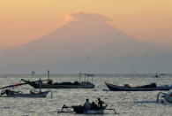 Mount Agung, an active volcano located on the resort island of Bali that has been placed on alert level 3 following recent seismic activity, is seen from Mataram on nearby Lombok island, Indonesia September 21, 2017, in this photo taken by Antara Foto. Picture taken September 21, 2017. Antara Foto/Ahmad Subaidi/via REUTERS