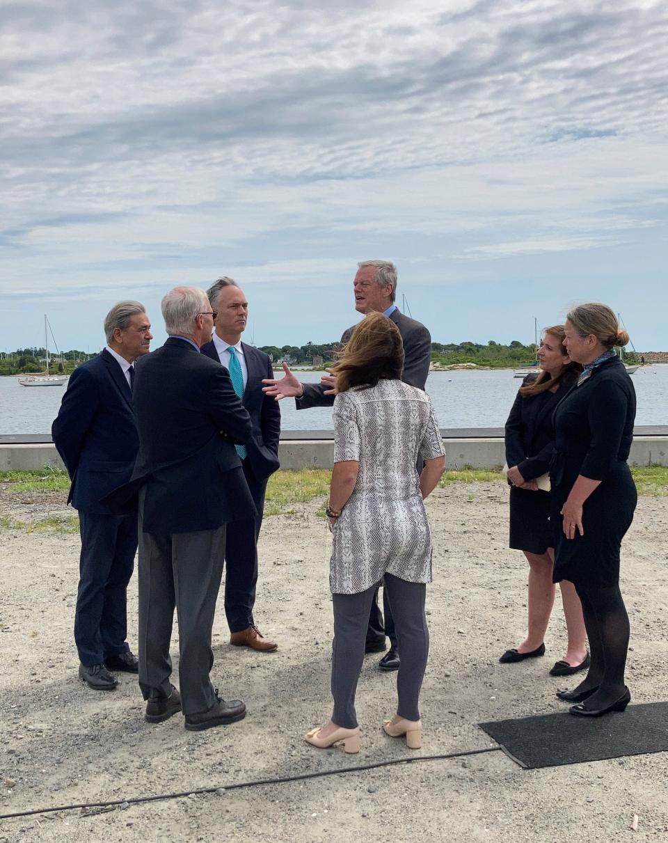 Gov. Charlie Baker speaks with Mayor Jon Mitchell and others at Thursday's announcement of the Offshore Wind Industry Ports Challenge at the New Bedford Marine Commerce Terminal.