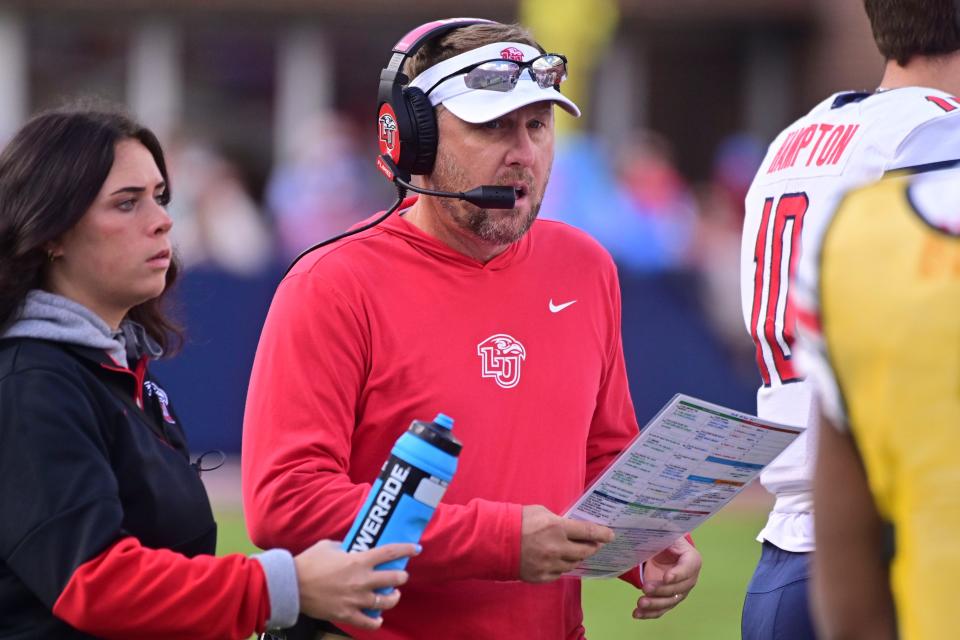 Liberty Flames head coach Hugh Freeze walks down the sideline during the first quarter against the Mississippi Rebels at Vaught-Hemingway Stadium.