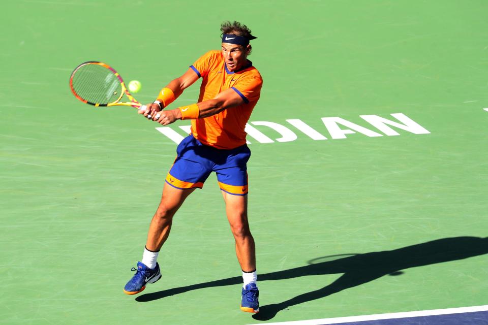 Rafael Nadal of Spain hits a return to American Taylor Fritz to during the men's final at the BNP Paribas Open in Indian Wells, Calif., on Sunday, March 2022.
