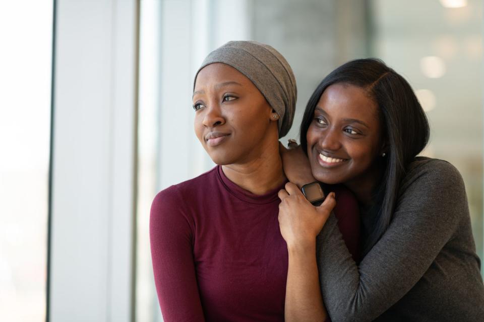 Young woman with cancer spends time with a friend.