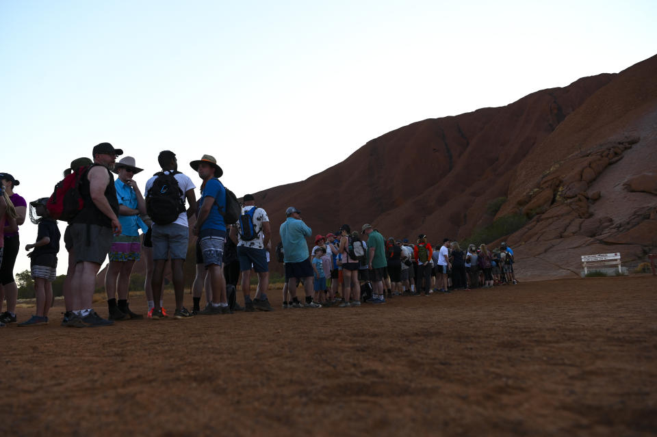 Tourists are seen lining up to climb Uluru, also known as Ayers Rock at Uluru-Kata Tjuta National Park. Source: AAP Image / Lukas Coch.