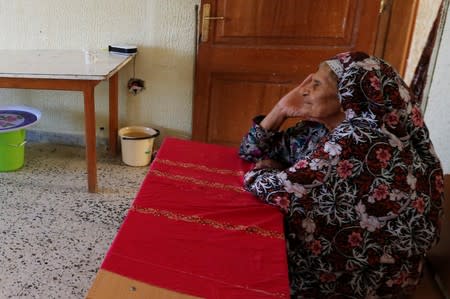 A Libyan displaced Mabrouka al-Twati, 80, who left her home after clashes, is seen in a class room in a school used as a shelter in Abu Slim district in Tripoli