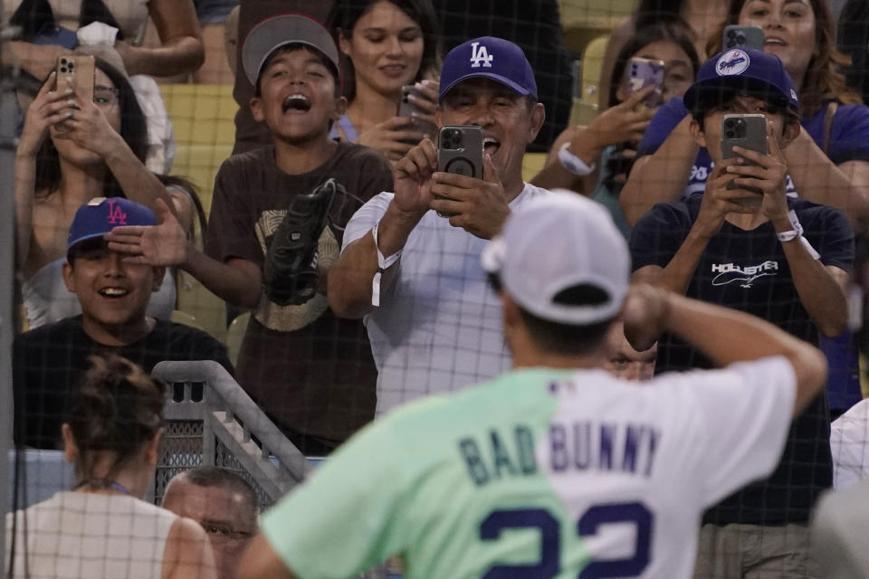 Fans take photos for rapper and singer Bad Bunny during the MLB All Star Celebrity Softball game, Saturday, July 16, 2022, in Los Angeles. (AP Photo/Mark J. Terrill)