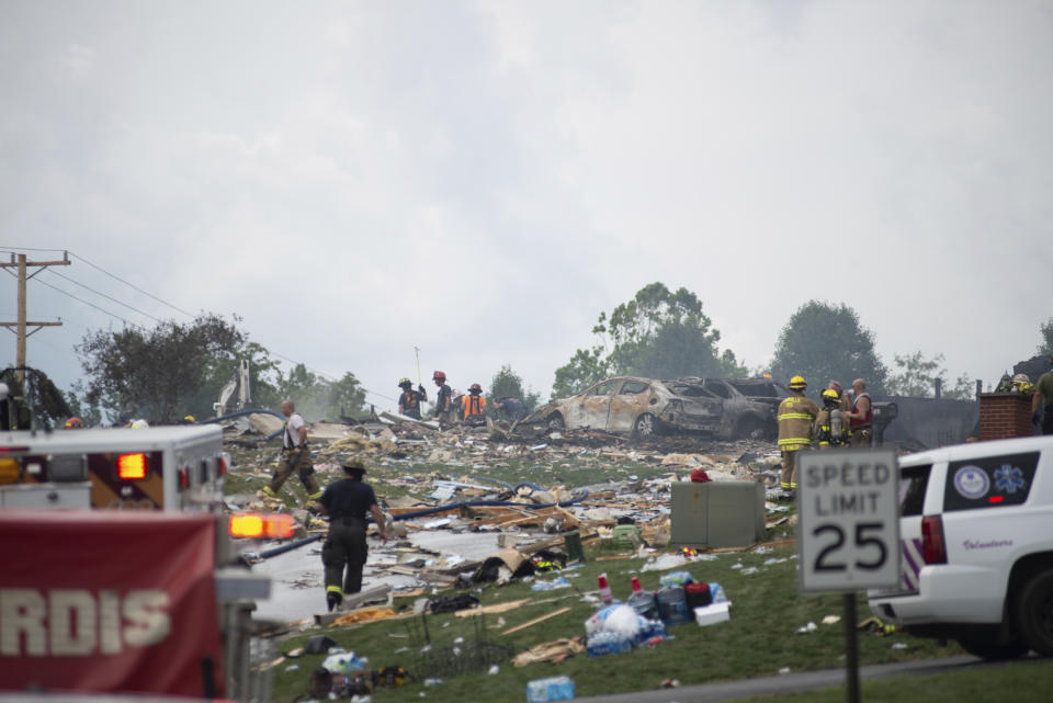 Police and emergency services search the wreckage of the three houses that exploded near Rustic Ridge Drive and Brookside Drive in Plum, Pa., on Saturday, Aug. 12, 2023. (Samuel Long/Pittsburgh Post-Gazette via AP/Pittsburgh Post-Gazette via AP)
