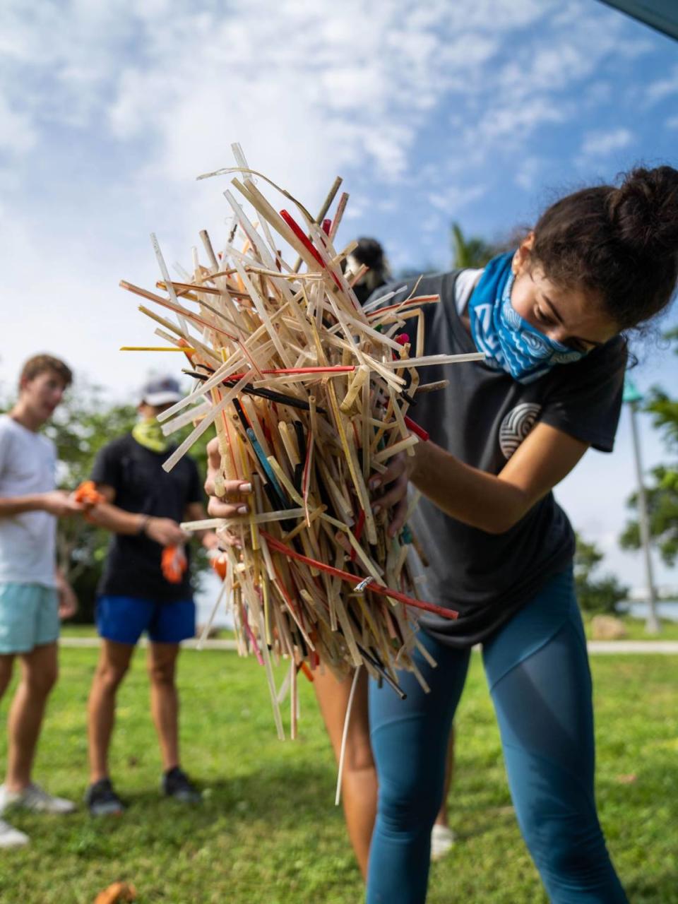 Sendit4thesea Volunteer Brittney Silva holds up plastics straws recovered from clean-ups around the Miami area.