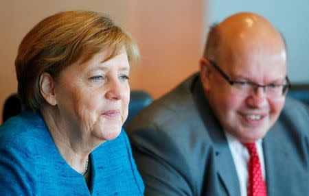 German Chancellor Angela Merkel and Head of the Chancellery Peter Altmaier attend the weekly cabinet meeting at the Chancellery in Berlin, Germany April 12, 2017. REUTERS/Hannibal Hanschke