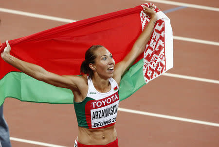 Marina Arzamasova of Belarus holds her national flag after winning the women's 800 metres final at the 15th IAAF Championships at the National Stadium in Beijing, China August 29, 2015. REUTERS/David Gray