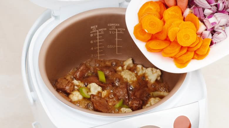 adding vegetables to slow cooker