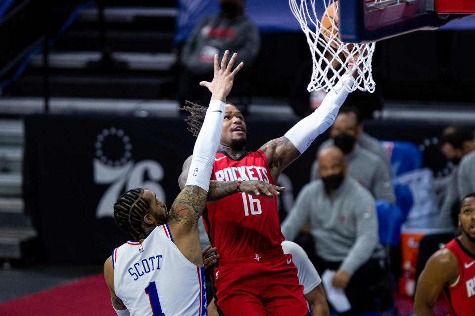 Feb 17, 2021; Philadelphia, Pennsylvania, USA; Houston Rockets guard Ben McLemore (16) goes to the basket against Philadelphia 76ers forward Mike Scott (1) during the second quarter at Wells Fargo Center. 