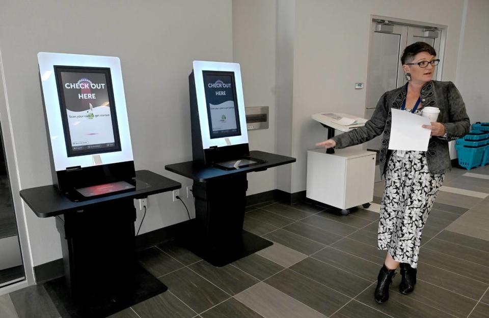 Branch Supervisor Tiffany Mautino points out a check-out kiosk at the county’s newest library. The Lakewood Ranch Library at 16410 Rangeland Parkway will open Friday, Jan. 12, 2024. Tiffany Tompkins/ttompkins@bradenton.com