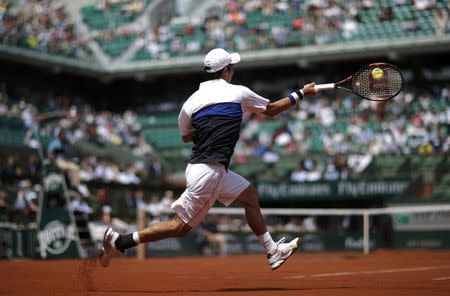 Kei Nishikori of Japan plays a shot to Thomaz Bellucci of Brazil during their men's singles match at the French Open tennis tournament at the Roland Garros stadium in Paris, France, May 27, 2015. REUTERS/Gonzalo Fuentes