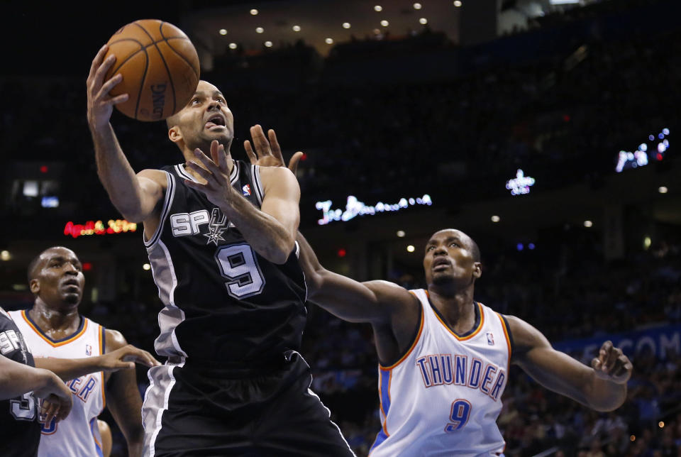 San Antonio Spurs guard Tony Parker (9) shoots in front of Oklahoma City Thunder forward Serge Ibaka (9) and center Kendrick Perkins during the third quarter of an NBA basketball game in Oklahoma City, Thursday, April 3, 2014. Oklahoma City won 106-94. (AP Photo/Sue Ogrocki)