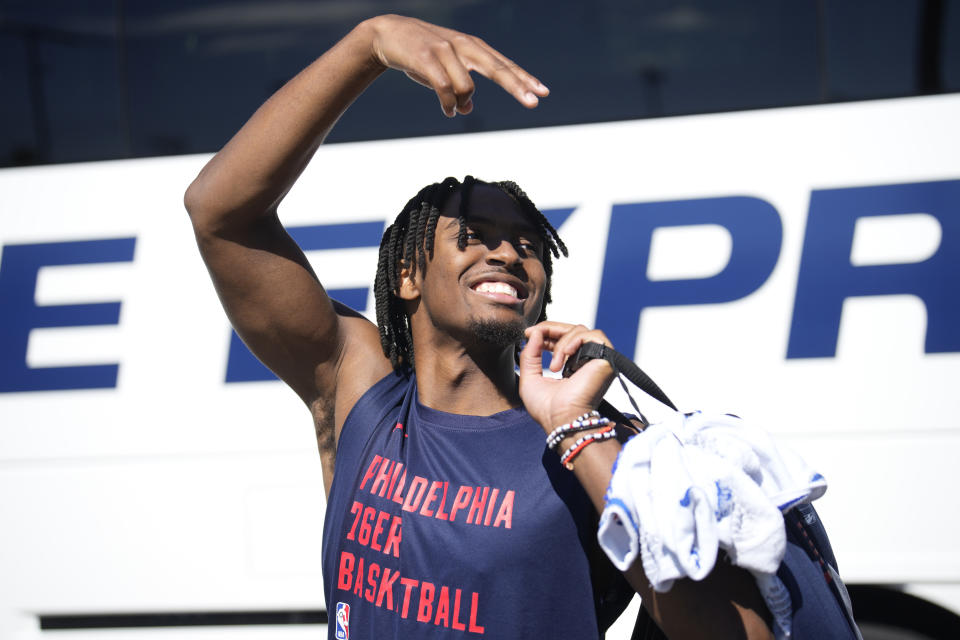 Philadelphia 76ers guard Tyrese Maxey waves to students as he boards a bus after the NBA basketball team's practice on the caampus of Colorado State University on Thursday, Oct. 5, 2023, in Fort Collins, Colo. (AP Photo/David Zalubowski)