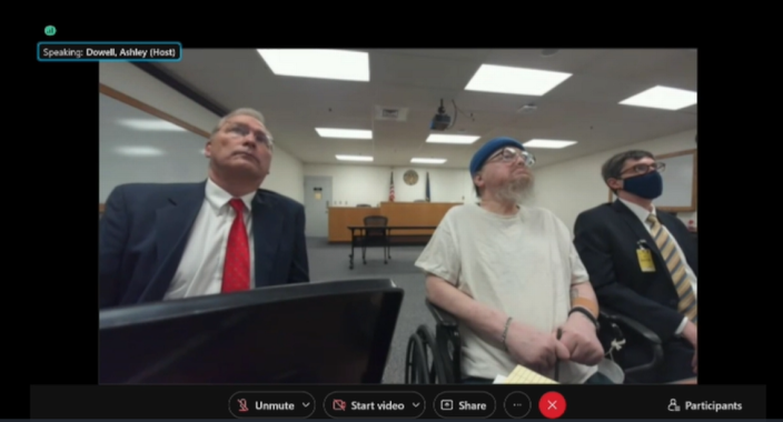 Idaho death row inmate Gerald Pizzuto, center, attends his state parole board clemency hearing seated next to one of his public defenders, Bruce Livingston, left, in November 2021. Pizzuto is terminally ill and has avoided execution five times since his 1986 murder conviction.
