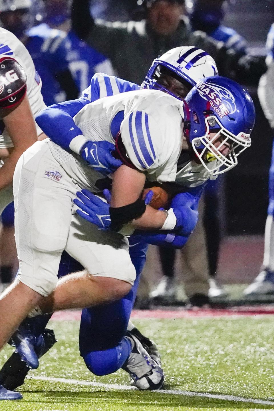 Clinton-Massie running back Gavan Hunter (8) fights for yards as Wyoming defensive end Deuce Wiley (8) makes the tackle during the second half of an OHSAA Division IV high school football regional semifinal at Lakota West High School, Saturday, Nov. 12, 2022.