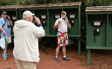 FILE PHOTO: Patrons use landline phones to call out as cell phones are not allowed on the course during Monday practice rounds for the 2017 Masters at Augusta National Golf Course in Augusta, Georgia, U.S., April 3, 2017. REUTERS/Jonathan Ernst/File Photo