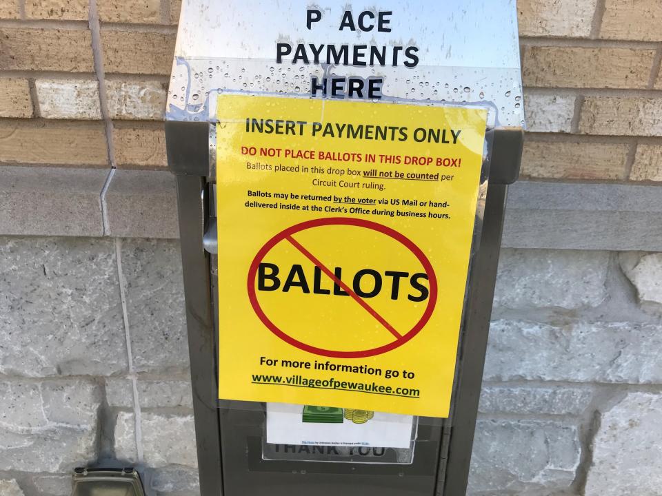 Village of Pewaukee officials placed a notice on one of their payment boxes to ensure voters did not drop absentee ballots inside following a recent court ruling banning the use of voting by drop box.