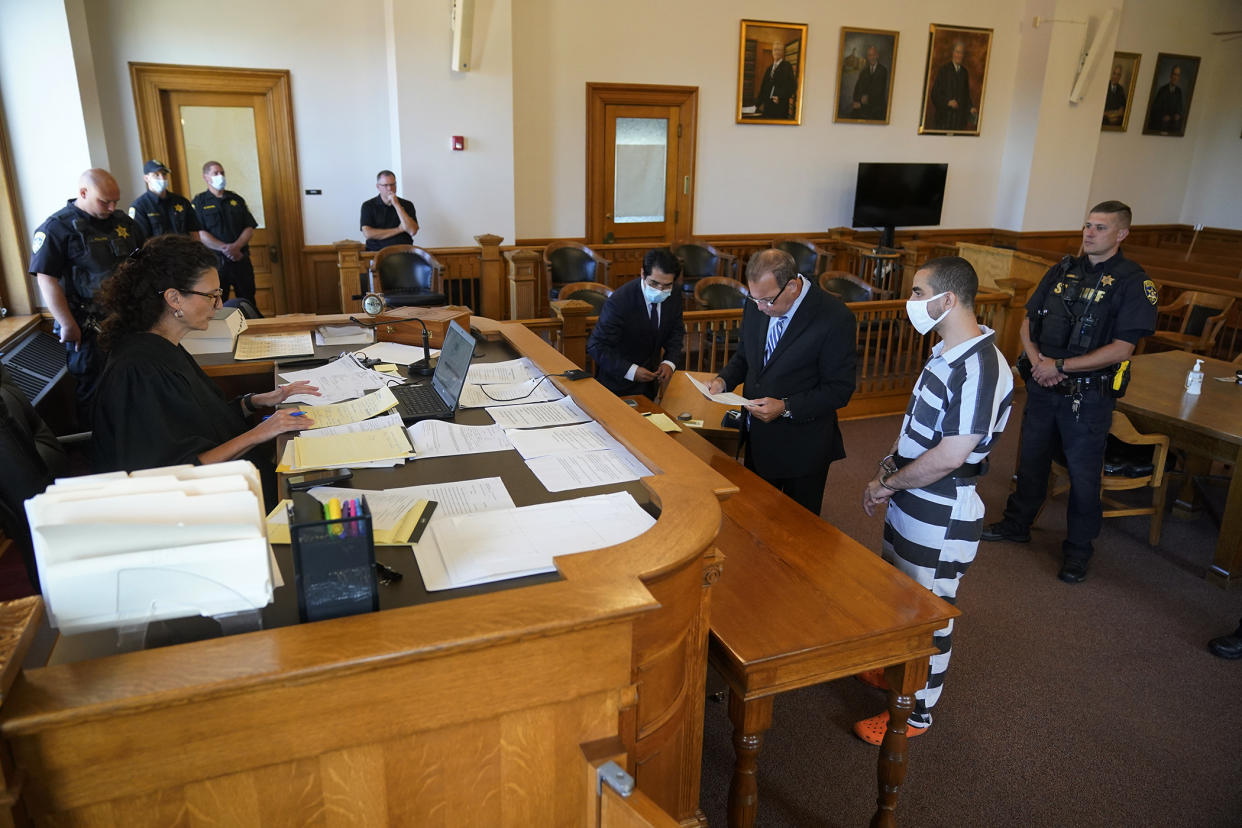 Hadi Matar, 24, second from right, listens as his public defense attorney Nathaniel Barone, center, addresses the judge while being arraigned in the Chautauqua County Courthouse in Mayville, NY., Saturday, Aug. 13, 2022. Matar, accused of carrying out a stabbing attack against “Satanic Verses” author Salman Rushdie, has entered a not-guilty plea on charges of attempted murder and assault. (AP Photo/Gene J. Puskar)