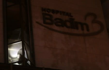 Firefighters work after a fire hit the Badim Hospital in Rio de Janeiro