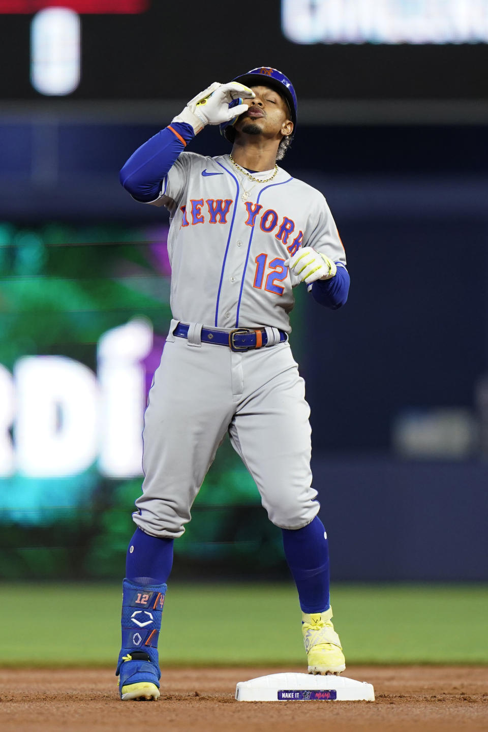 New York Mets' Francisco Lindor celebrates after hitting a double during the first inning of a baseball game against the Miami Marlins, Sunday, July 31, 2022, in Miami. (AP Photo/Wilfredo Lee)