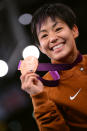 Bronze medalist A <a href="http://sports.yahoo.com/olympics/wrestling/clarissa-kyoko-mei-ling-chun-1130413/" data-ylk="slk:Clarissa Kyoko Mei Ling Chun;elm:context_link;itc:0;sec:content-canvas" class="link ">Clarissa Kyoko Mei Ling Chun</a> of the United States stands on the podium in the Women's Freestyle 48 kg Wrestling on Day 12 of the London 2012 Olympic Games at ExCeL on August 8, 2012 in London, England. (Photo by Lars Baron/Getty Images)