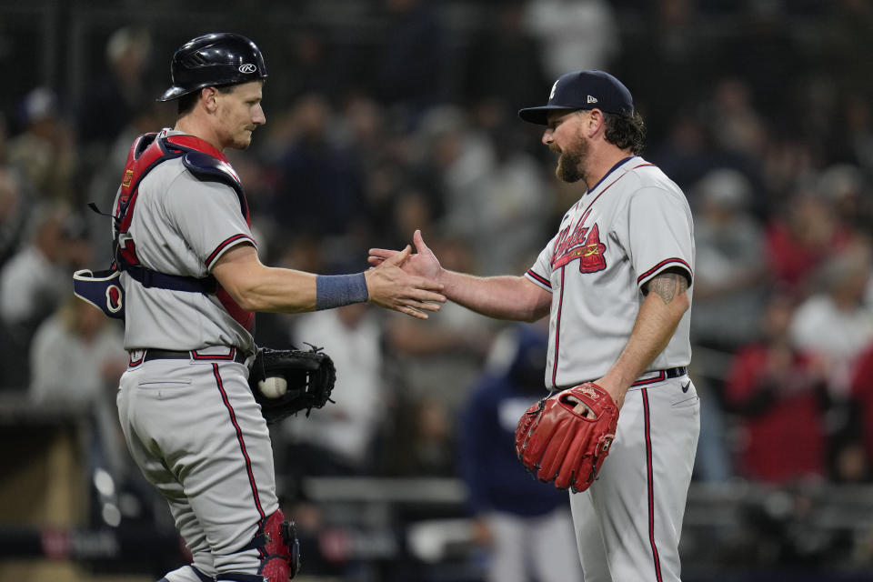 Atlanta Braves relief pitcher Kirby Yates, right, celebrates with teammate catcher Sean Murphy after the Braves defeated the San Diego Padres 8-1 in a baseball game Tuesday, April 18, 2023, in San Diego. (AP Photo/Gregory Bull)