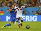 Greece's Andreas Samaris (L) fouls Costa Rica's Joel Campbell during their 2014 World Cup round of 16 game at the Pernambuco arena in Recife June 29, 2014. The foul resulted a yellow card for Samaris , REUTERS/Brian Snyder