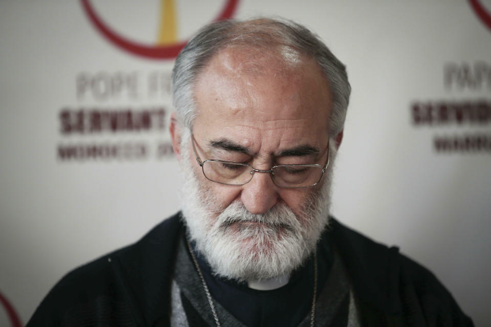 FILE - In this March 5, 2019 file photo Cristobal Lopez Romero, Rabat Archbishop takes notes during a presser at Casablanca's Notre Dame church to brief them on the upcoming papal visit, in Morocco. Bishop Romero is among 13 men Pope Francis admires, resembles and has chosen to honor as the 13 newest cardinals who will be elevated at a formal ceremony, Saturday, Oct. 5, 2019. (AP Photo/Mosa'ab Elshamy, file)