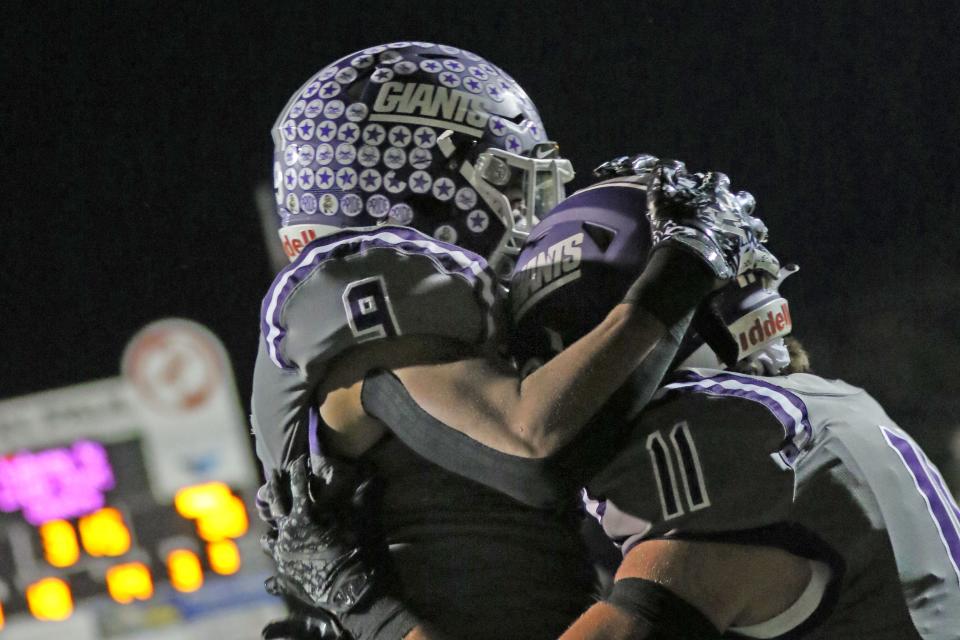 Ross' Bryson Hammer, left, hugs Adam Hrynciw after Hrynciw's touchdown.