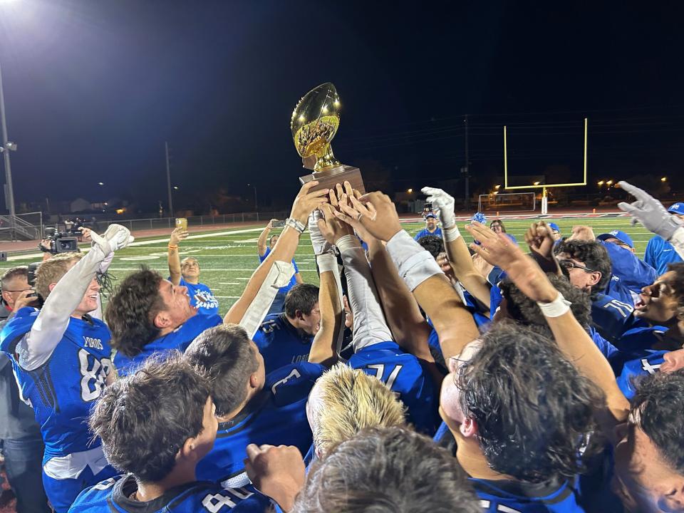 The Hayden Lobos gather for a team shot after beating the Mogollon Mustangs in the Arizona 1A high school football state championship.