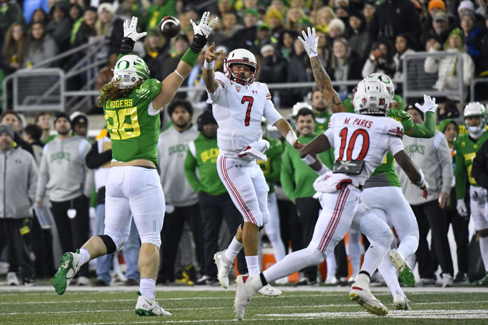 Oregon defensive lineman Casey Rogers (98) pressures Utah quarterback Cameron Rising (7) during the first half of an NCAA college football game Saturday, Nov. 19, 2022, in Eugene, Ore. (AP Photo/Andy Nelson)