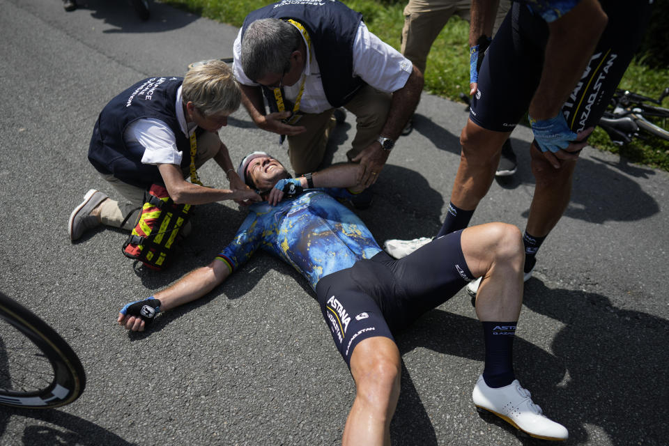 Britain's Mark Cavendish receives medical assistance after crashing during the eighth stage of the Tour de France cycling race over 201 kilometers (125 miles) with start in Libourne and finish in Limoges, France, Saturday, July 8, 2023. (AP Photo/Thibault Camus)