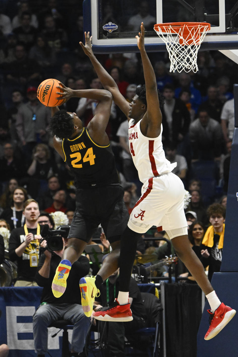 Missouri guard Kobe Brown (24) shoots as Alabama forward Noah Gurley defends during the second half of an NCAA college basketball game in the semifinals of the Southeastern Conference Tournament, Saturday, March 11, 2023, in Nashville, Tenn. Alabama won 72-61. (AP Photo/John Amis)