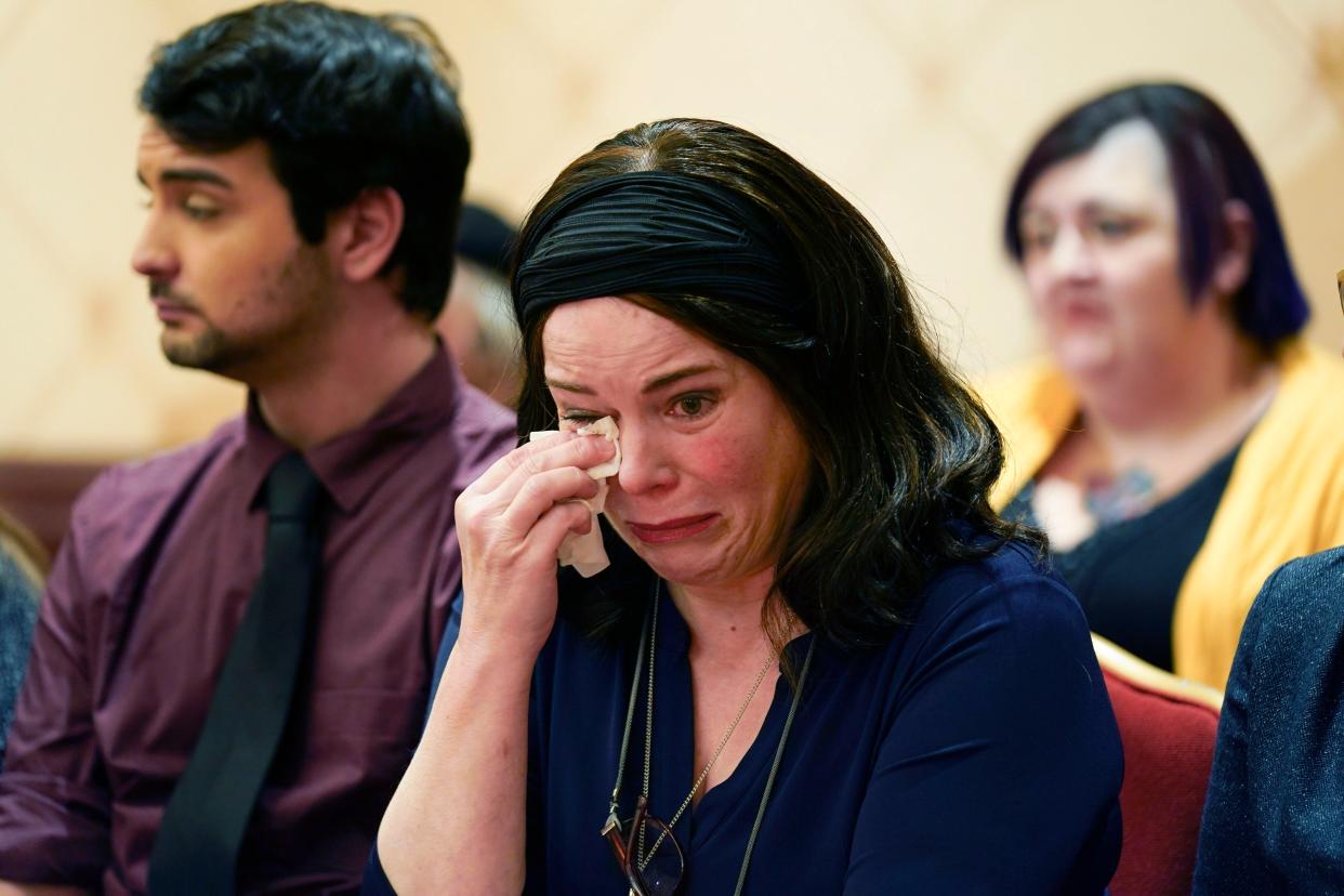 Veronique De La Rosa, mother of Noah Pozner, who was killed in the Sandy Hook Elementary School shooting, wipes away tears during a news conference in Trumbull, Conn., on Feb. 15, 2022. 