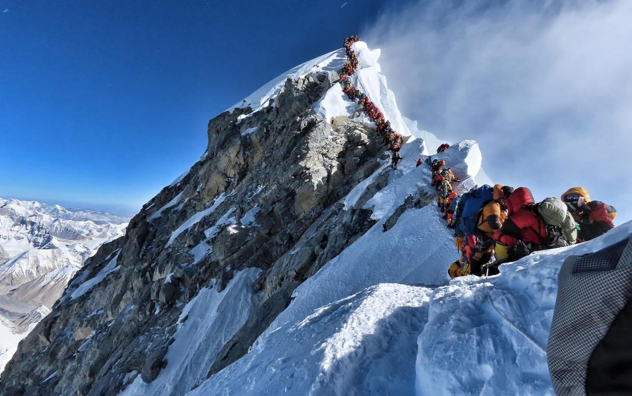 Many teams had to line up for hours on May 22 to reach the summit, as a rush of climbers marked one of the busiest days on the world's highest mountain - AFP